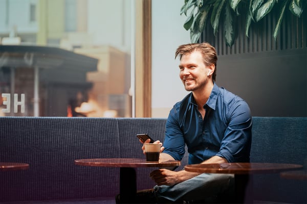 cafe-man-caucasian-mobile-blue-shirt-smile-window-dstny