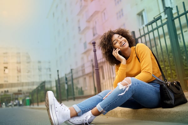 Woman-sitting-street-talking-phone