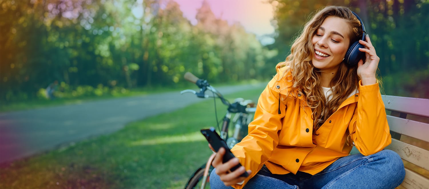 orange-raincoat-woman-headphones-bike