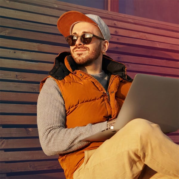 Man working on a laptop in the sunset