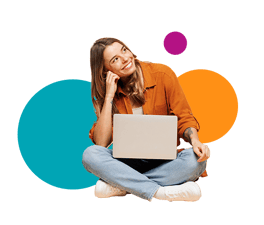 A woman sitting on the floor with a laptop in her lap. 