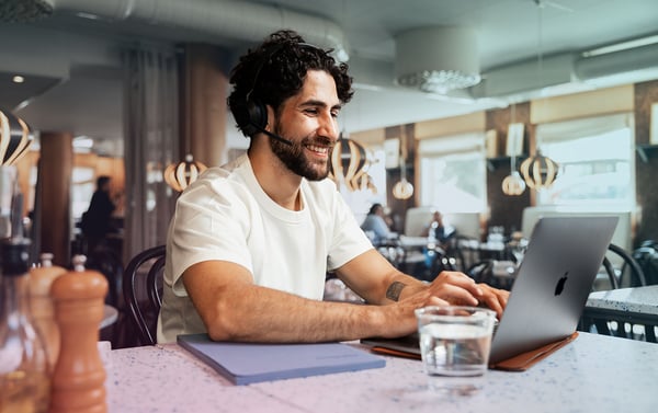 restaurant-man-latino-laptop-headset-typing-smiling-water-dstnyjpg