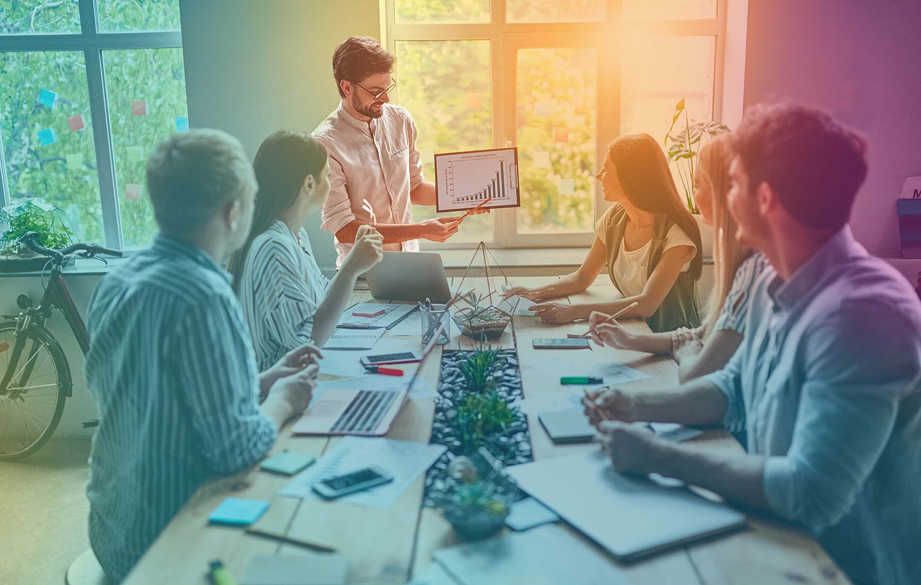 People in a meeting showing a screen